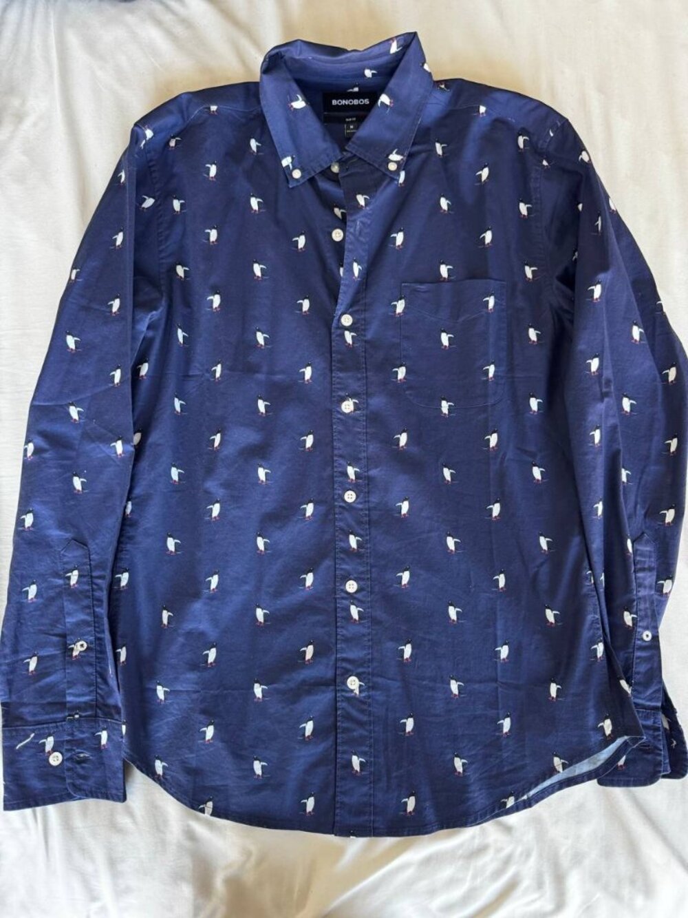 Bonobos slim fit button-down shirt in navy blue with an allover penguin print